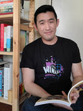 A black T-shirt with a purple and white castle behind a blue window frame. “2020 Winner” is in white text and “NaNoWriMo” is in purple text. Leaves, stars, clouds, and a book are scattered around the castle, and a long purple rose with a blue stem runs along the bottom.